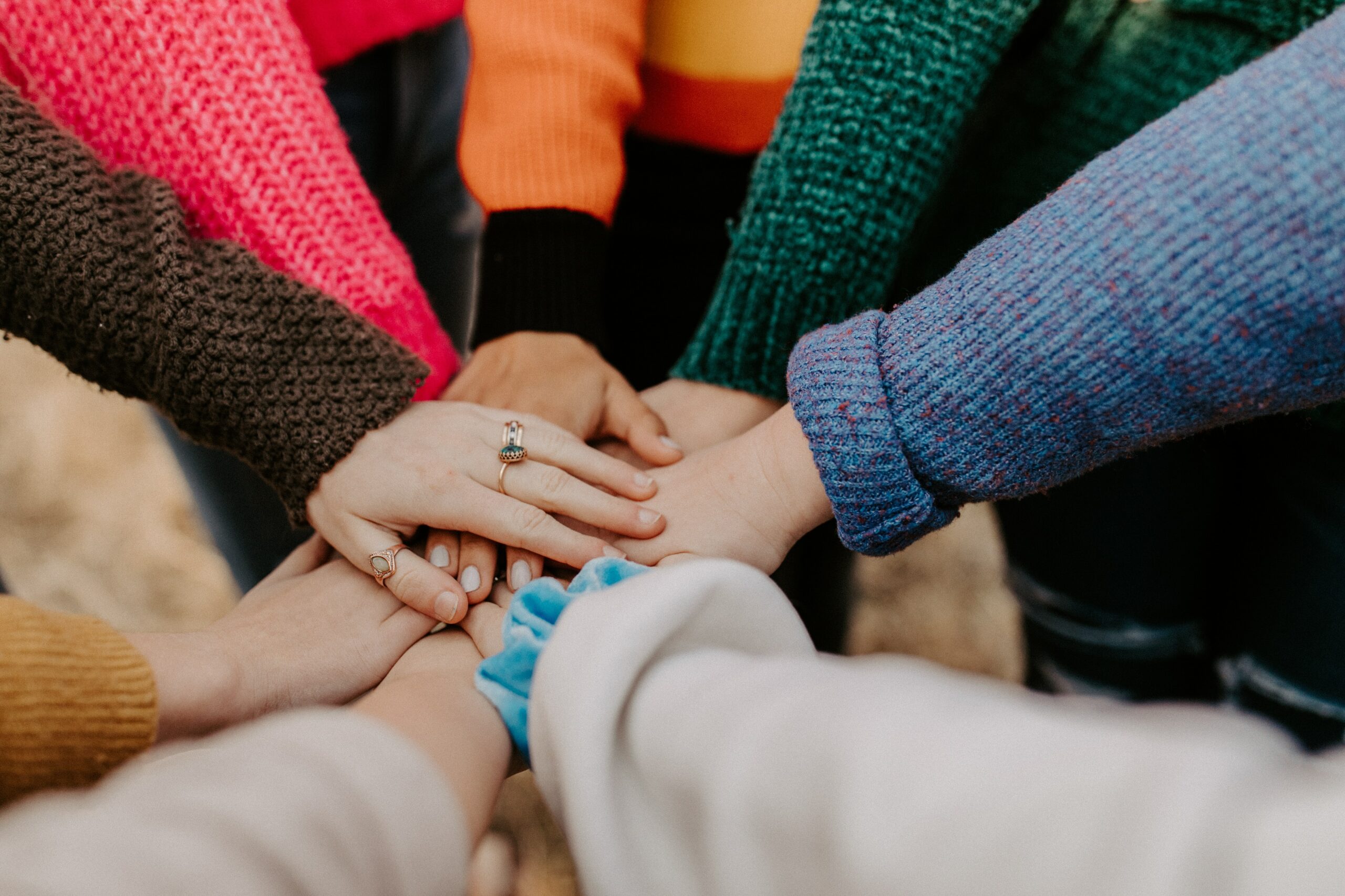 Different hands joined in a circle