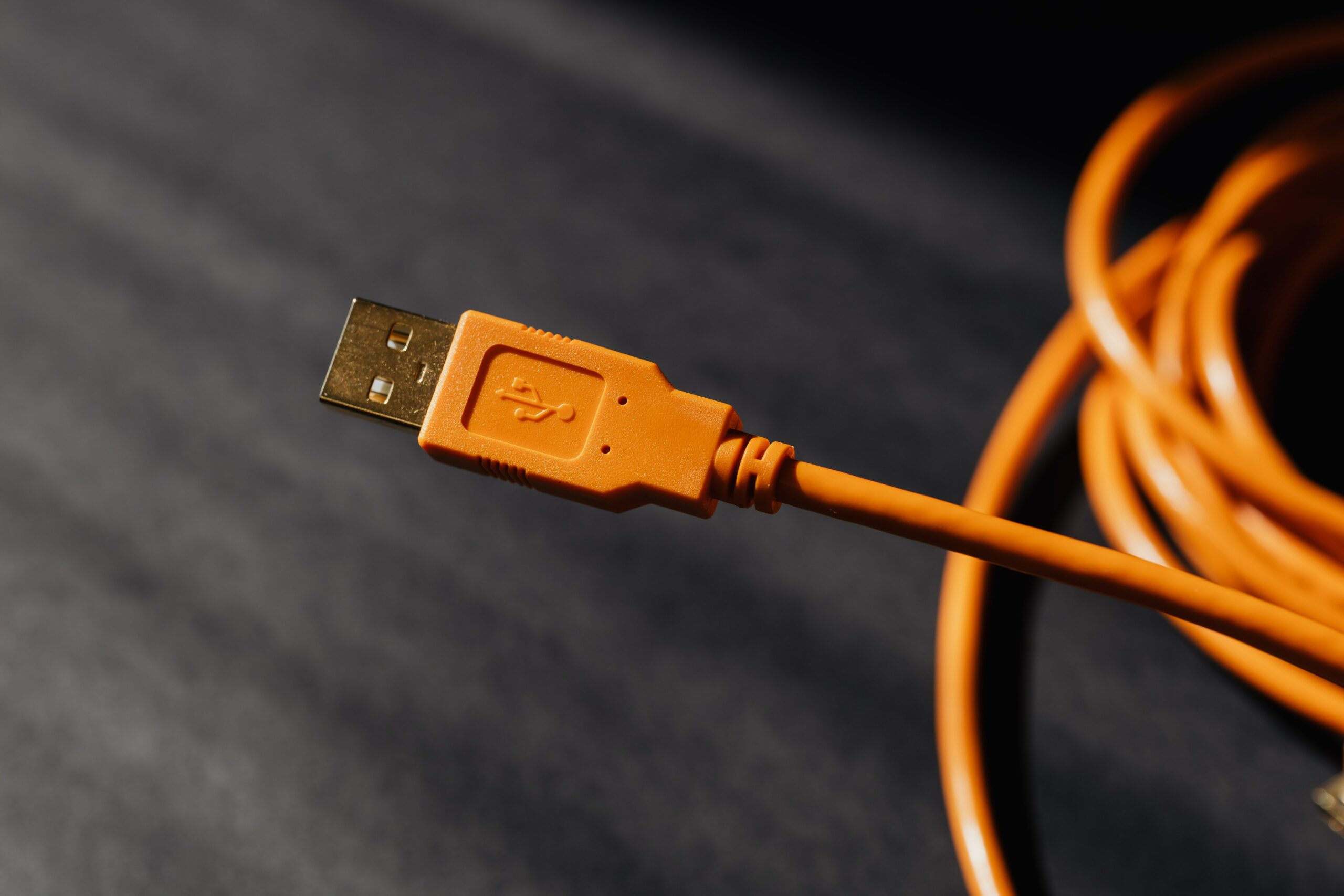 an orange USB cord on desk