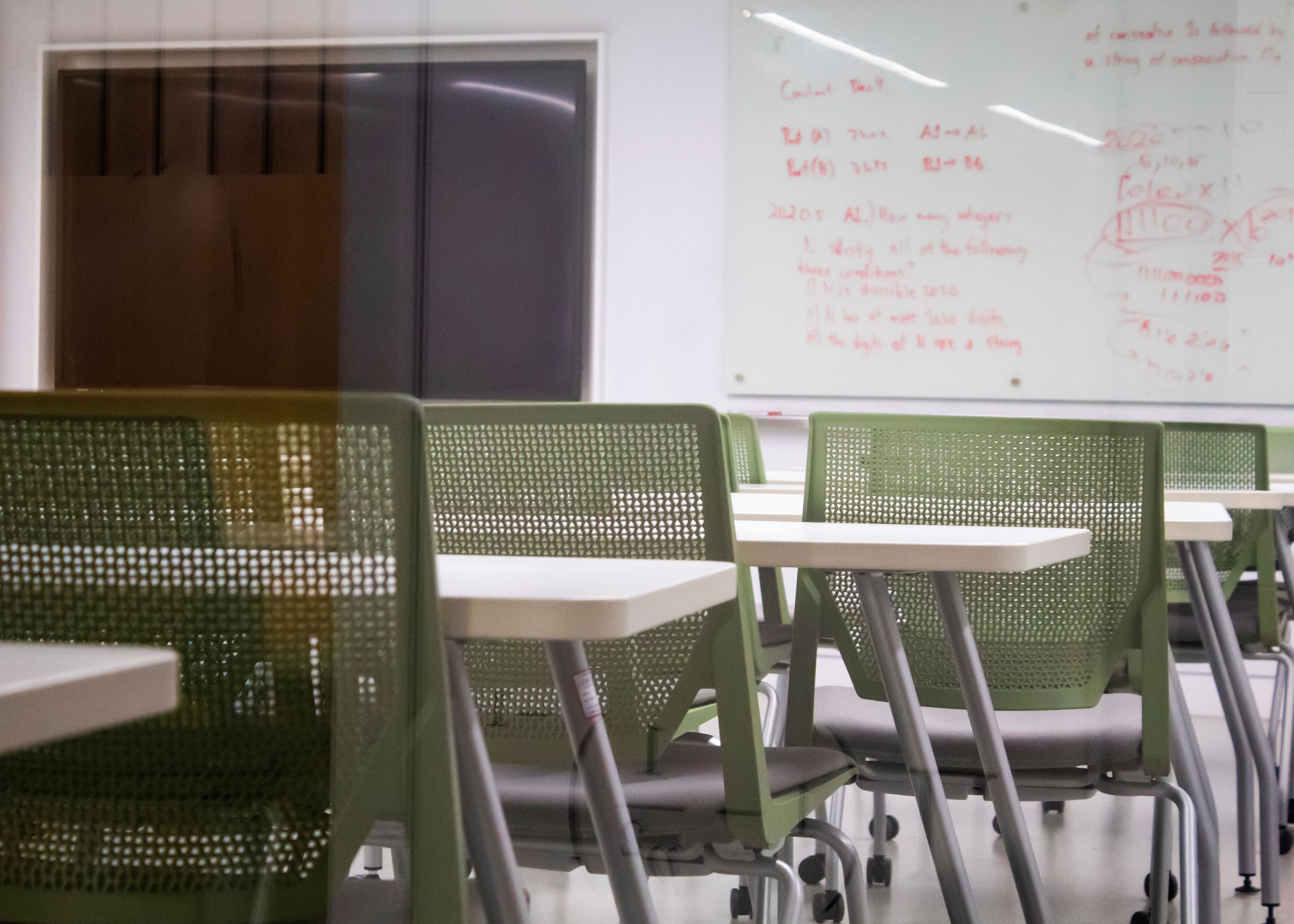 Empty classroom with green chairs in background