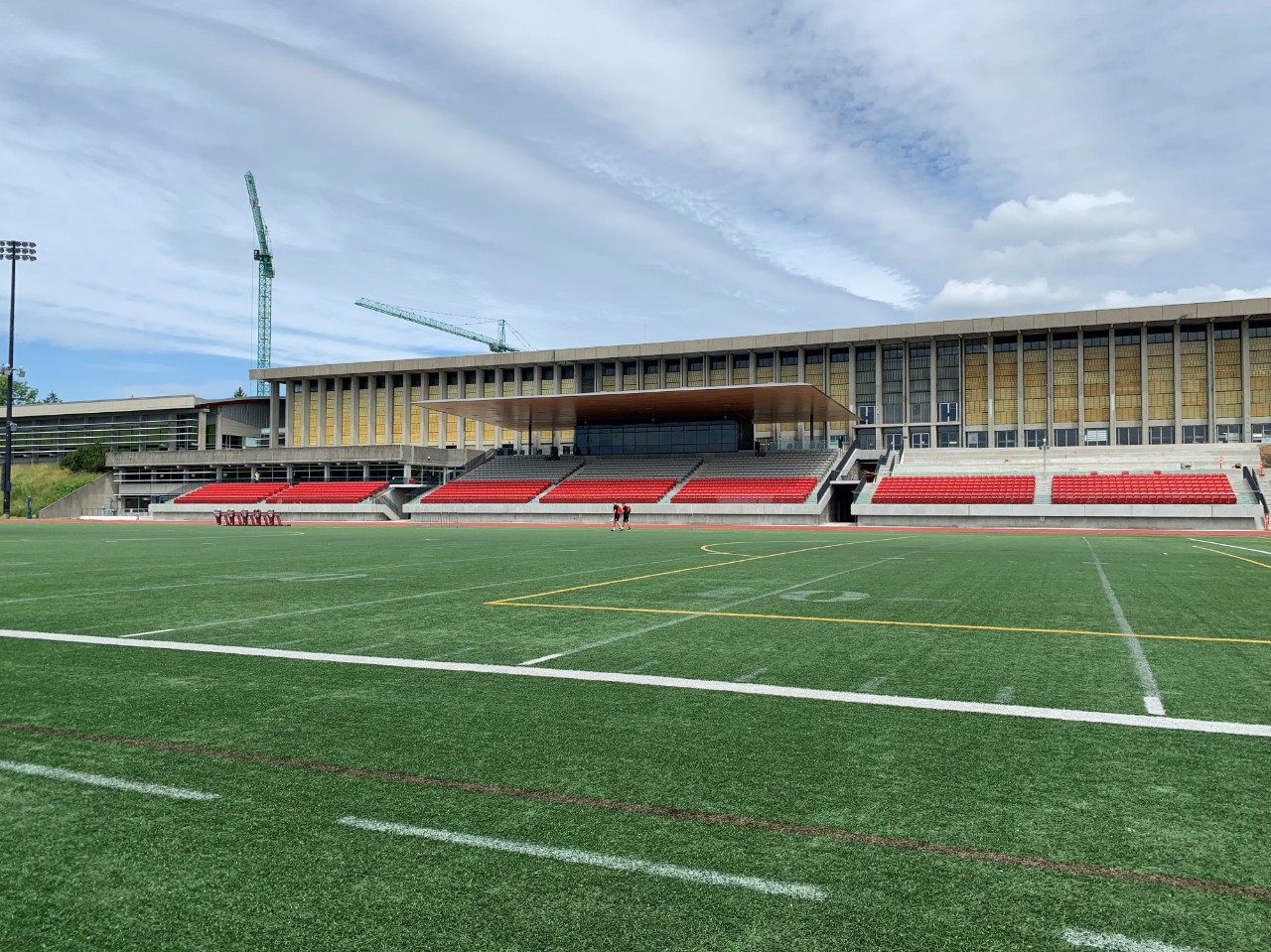 Photo of the Terry Fox Field at SFU with the Lorne Davis Centre in the background.