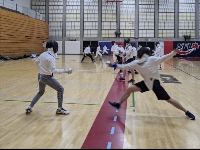 AD239A1E-182C-4414-9364-67618F39DE2E (1) A photo of a member of the SFU fencing team lunging at the other with a foil (sword) in hand.