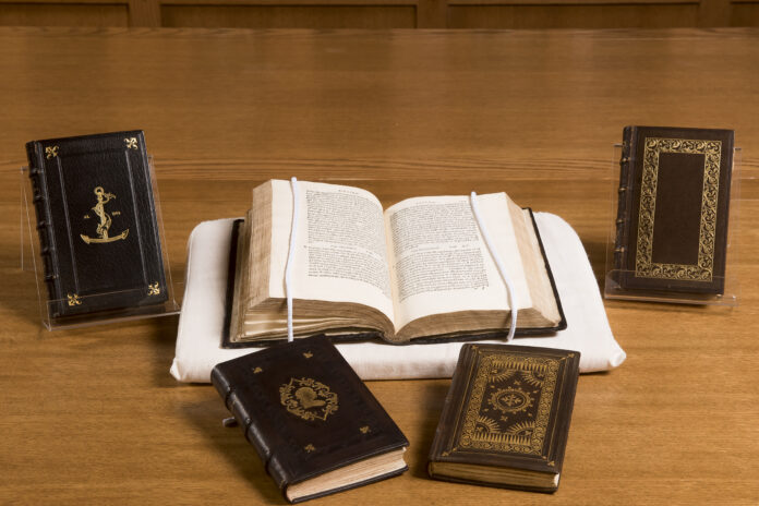 Old printed texts with brown covers on display
