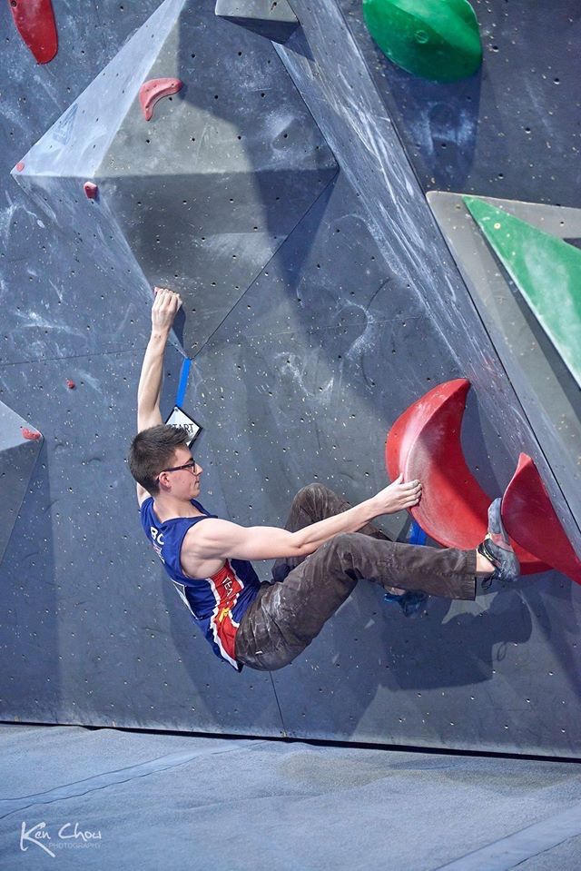 Geoff Arrowsmith propels up a rock climbing wall.