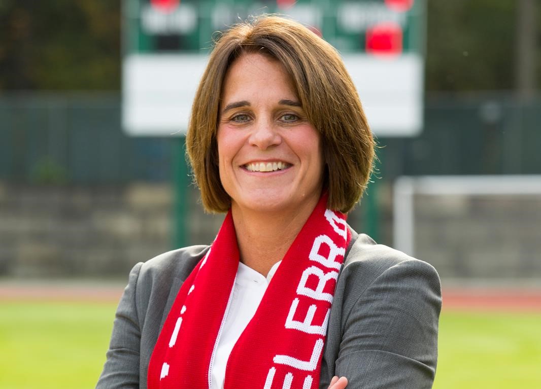 SFU Senior Director of Athletics and Recreation Theresa Hanson poses on the field for the camera.