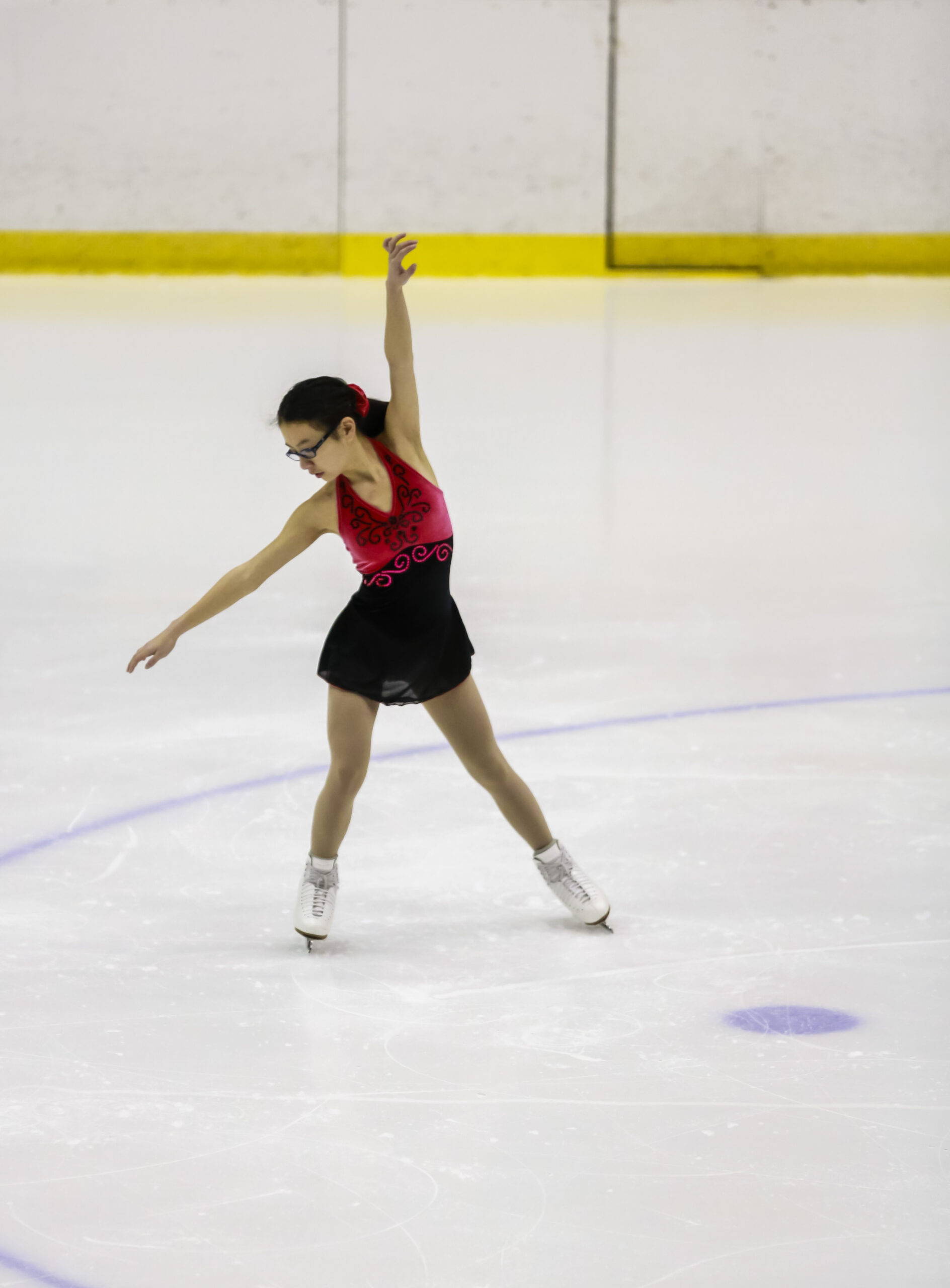 A photo of a figure skater posing on the ice during a figure skating performance.