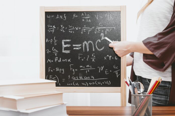 jeshoots-com-5EKw8Z7CgE4-unsplash (1) A chalkboard with E=MC squared written on it