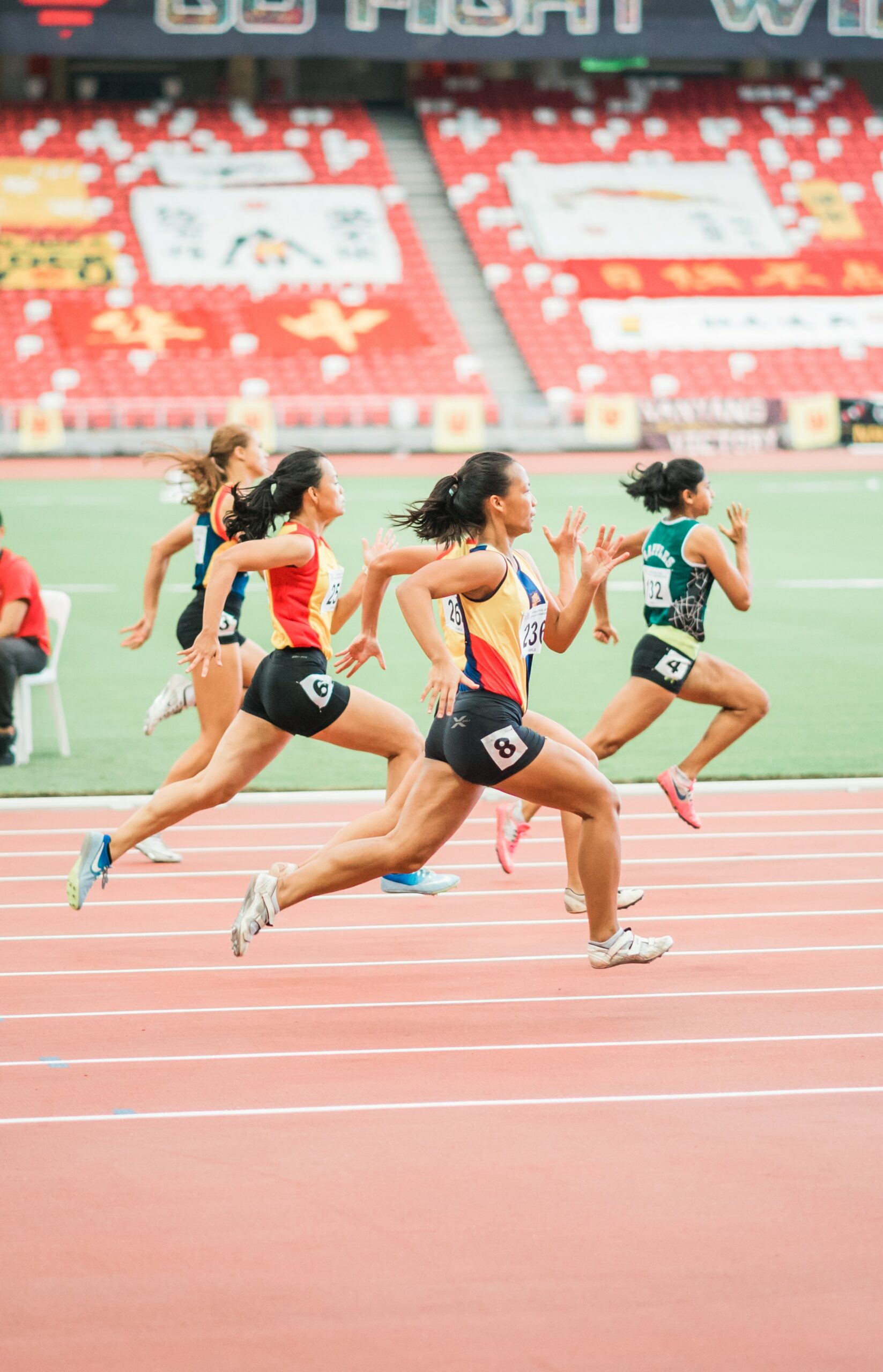 Shot of runners sprinting during a race. One runner has a clear advantage.