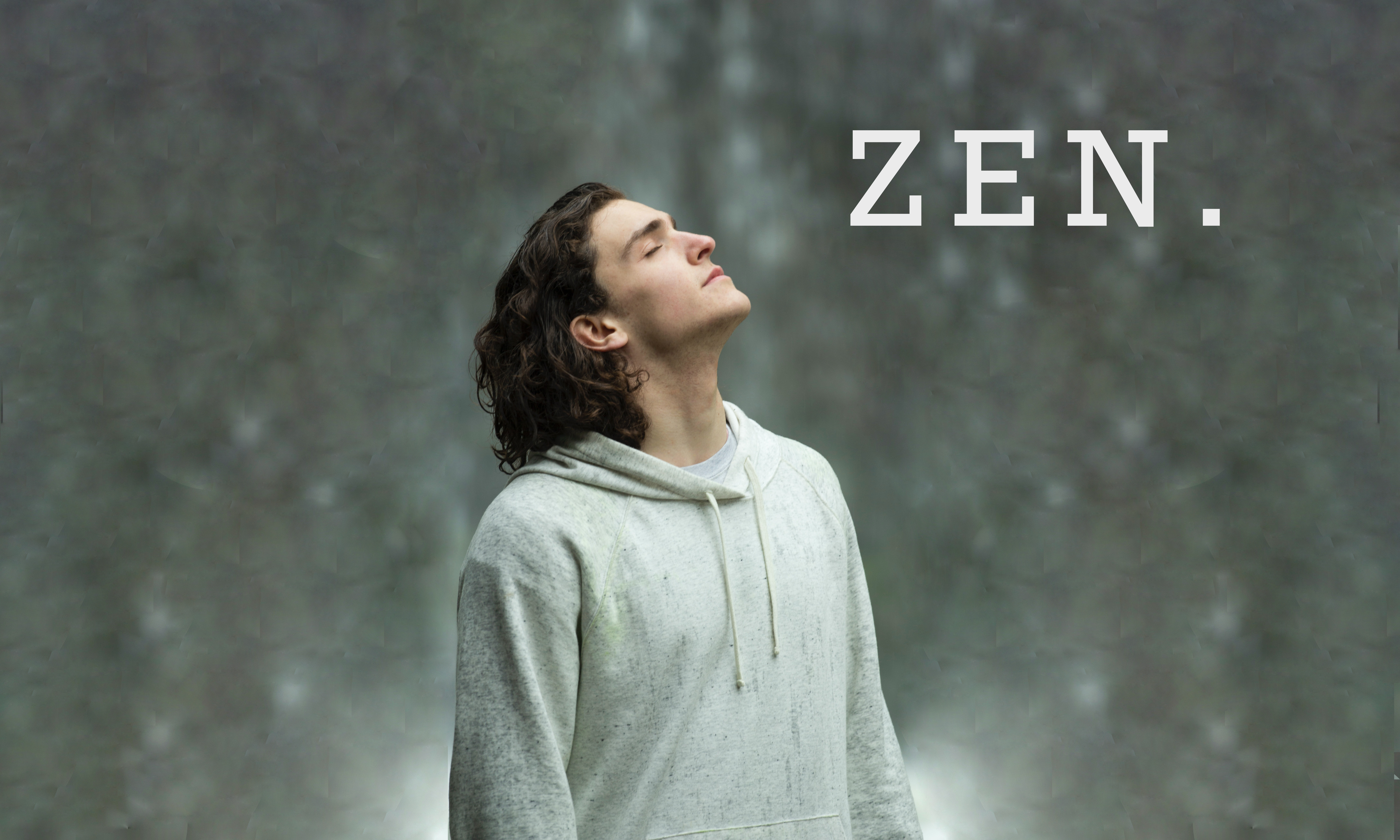 A peaceful, medium build man with slightly long hair the word ‘ZEN.’ in his eyeline