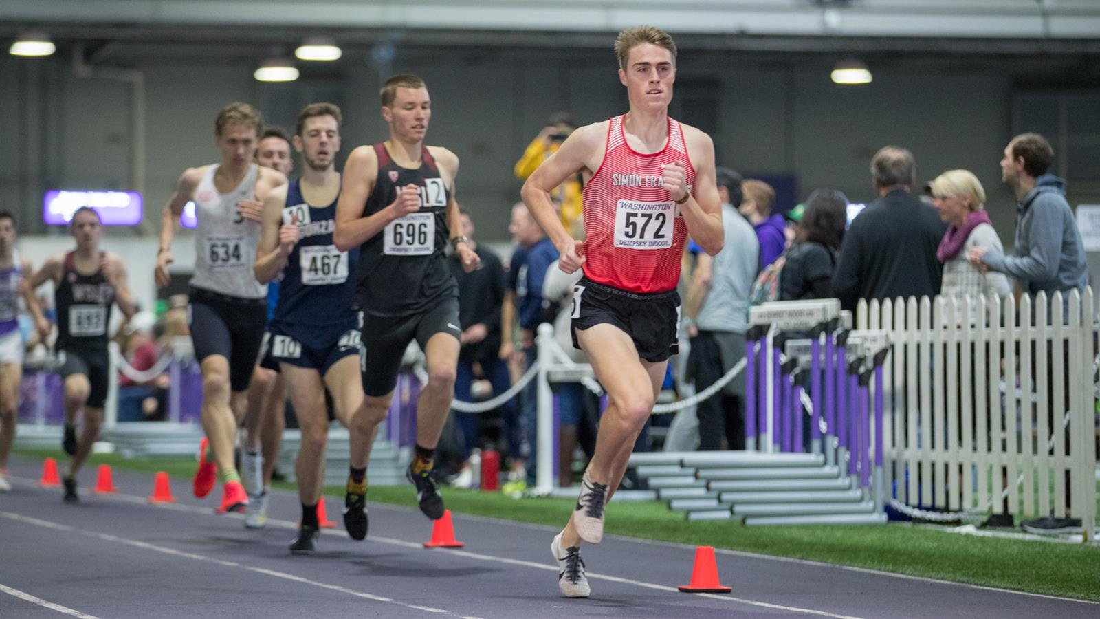 Photo of SFU runner Aaron Ahl leading the pack during an indoor race.