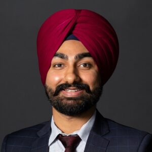 A headshot of Nijjar on a black background