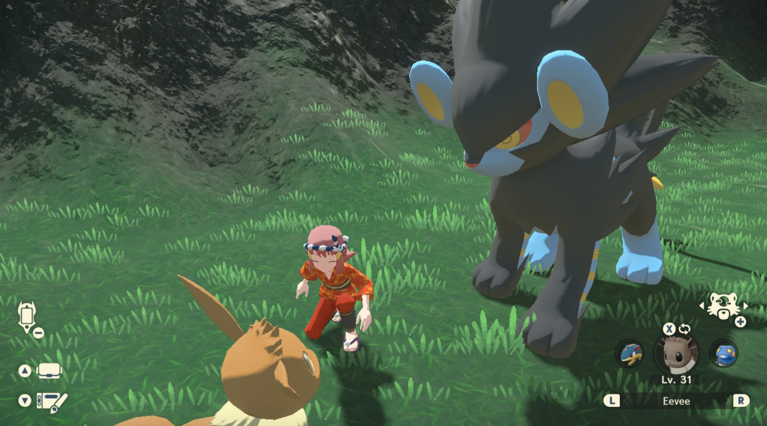 Screenshot from Pokémon Legends Arceus game, where a pink-haired player is crouched by a large eevee and an even larger Luxray in a grassy area