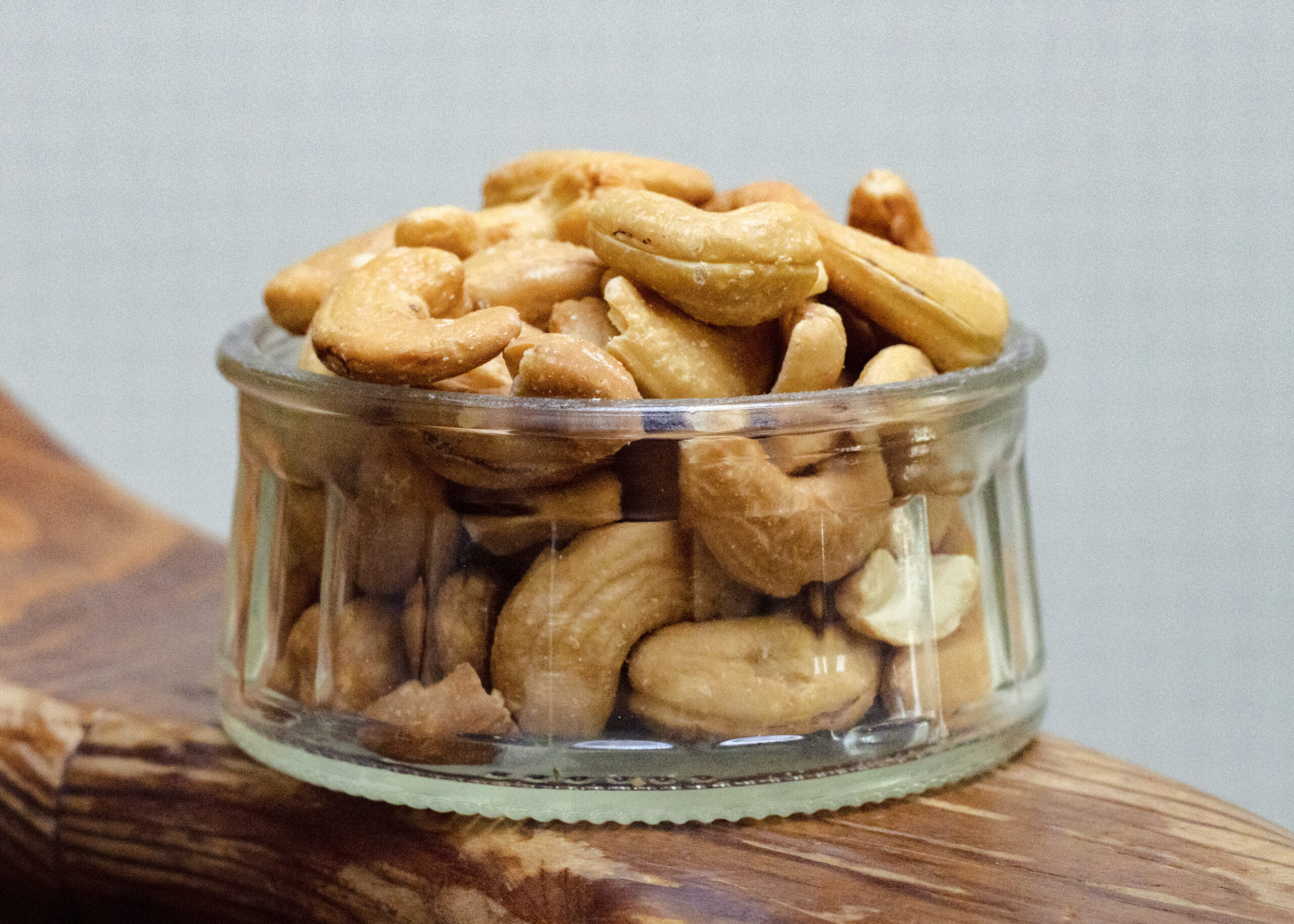 a clear glass jar with cashews inside