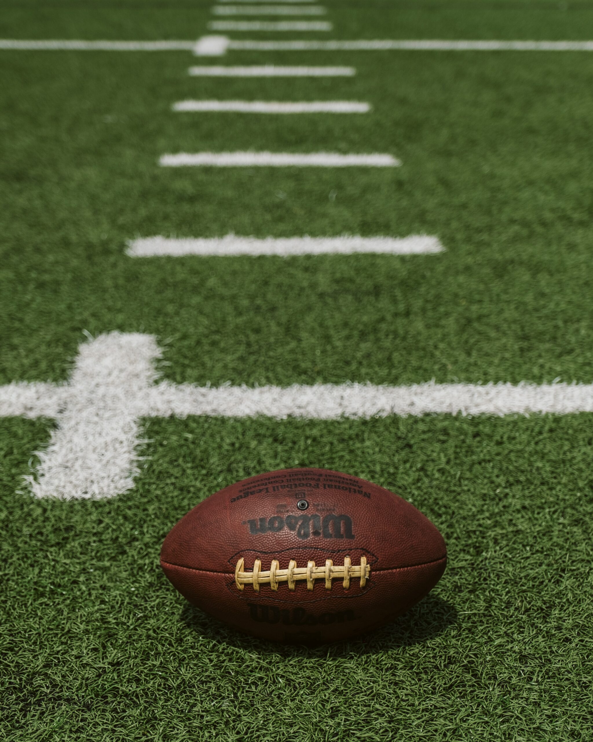 Up close shot of a football on an NFL field