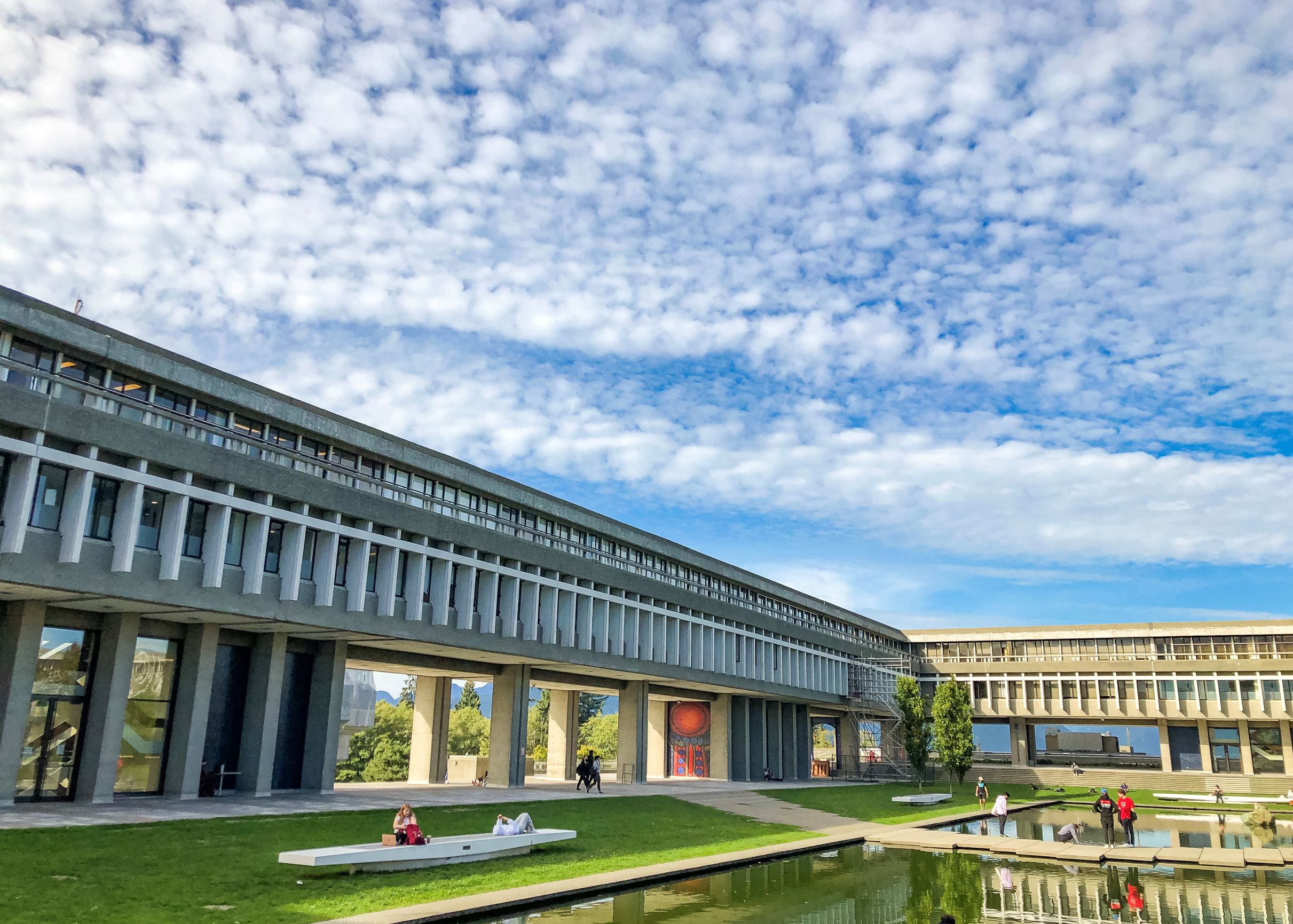 AQ building and pond with people in background