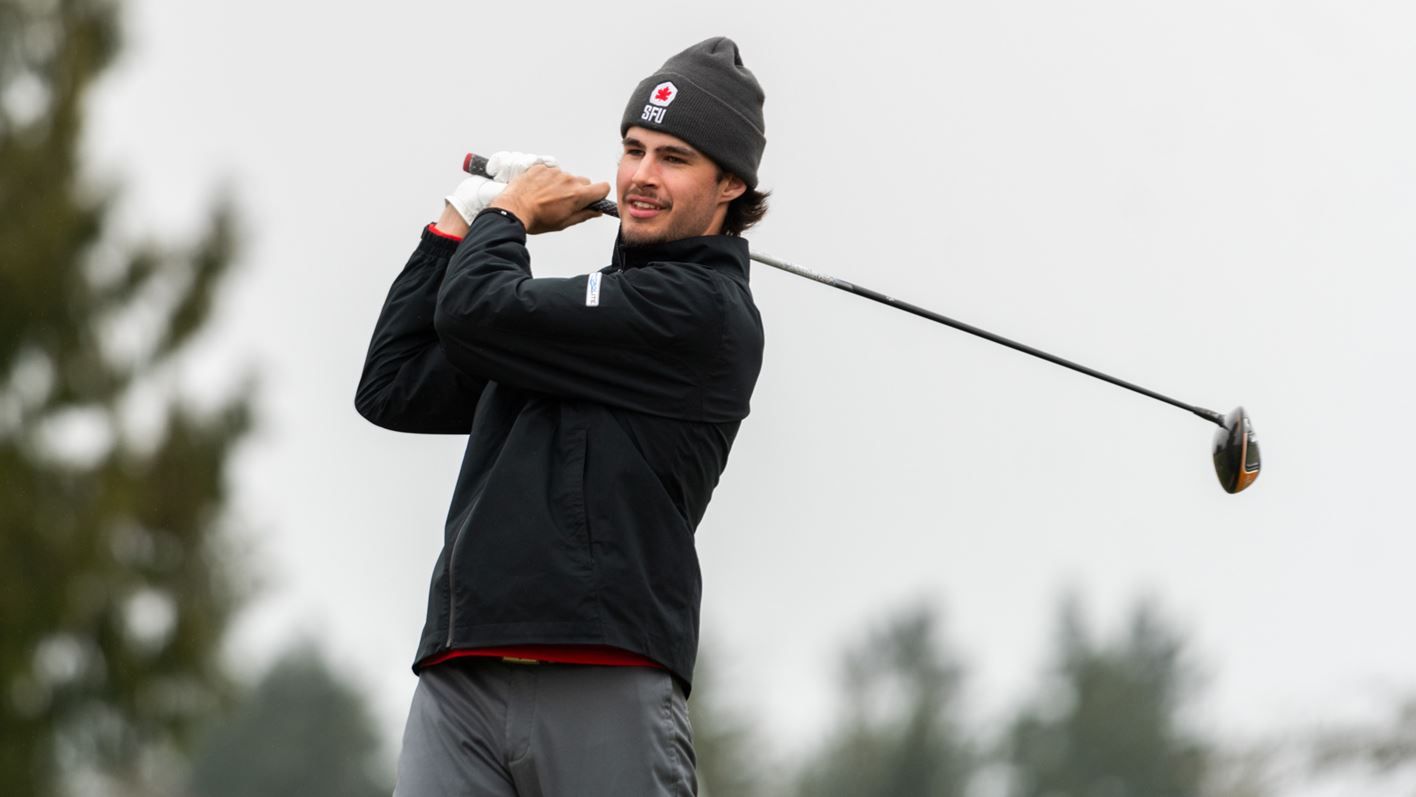 A photo of an SFU golfer looking at their shot after their swing.