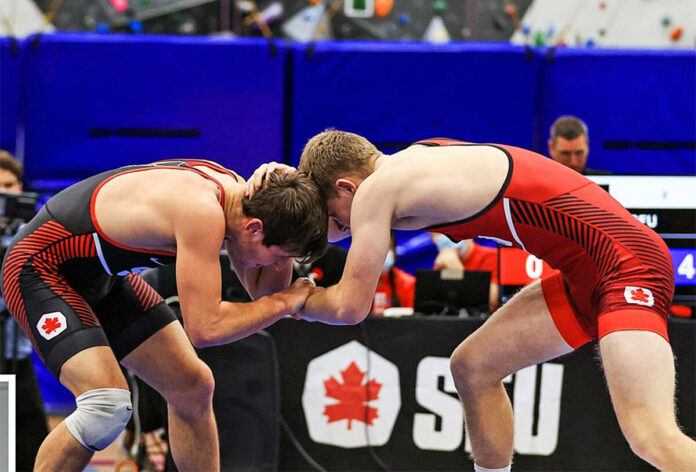 28005684_web1_220131-MRN-NC-wrestlers-pic_1 Two wrestlers engage in a headlock on the mat.