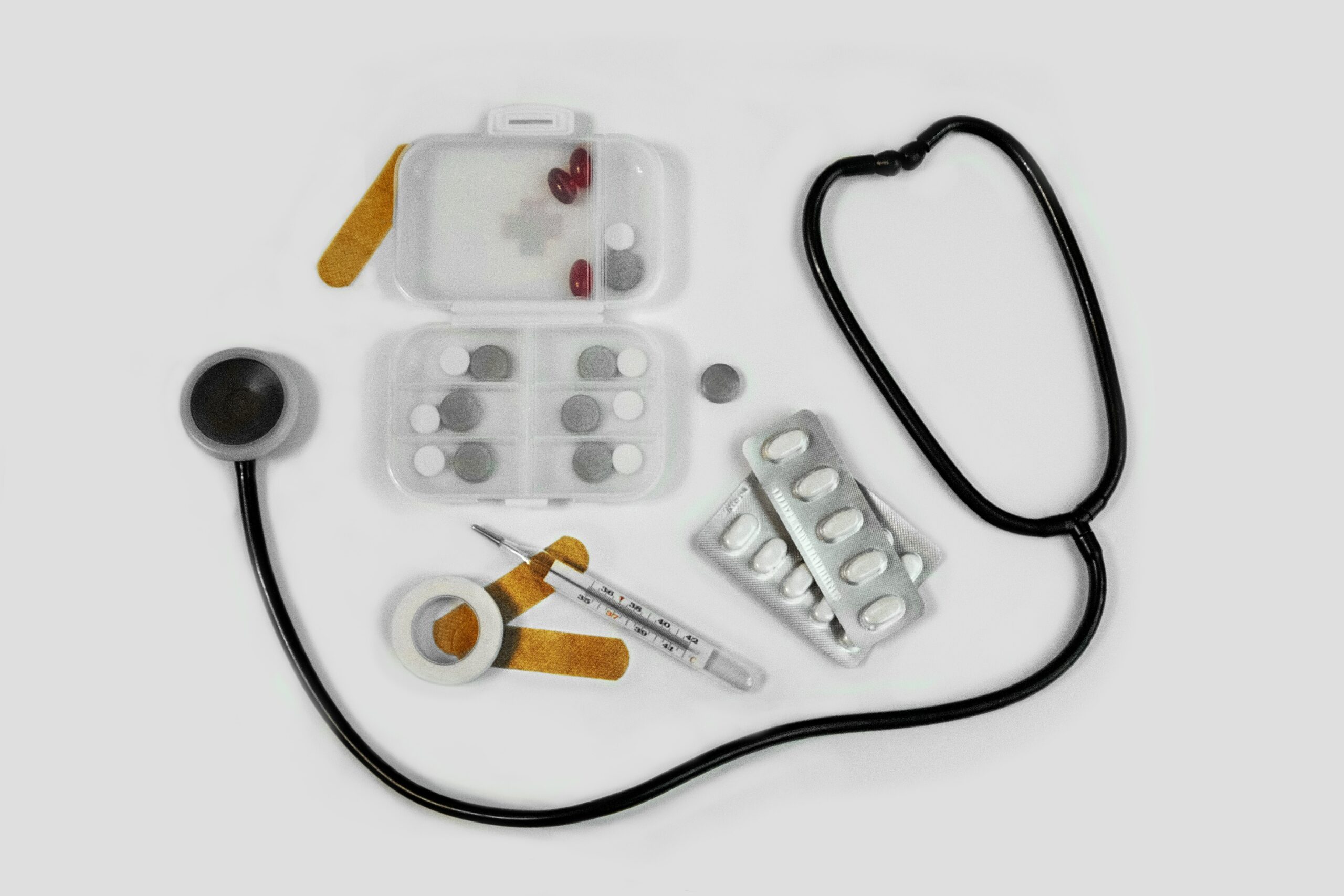 overhead shot of a stethoscope, medications, and syringe.