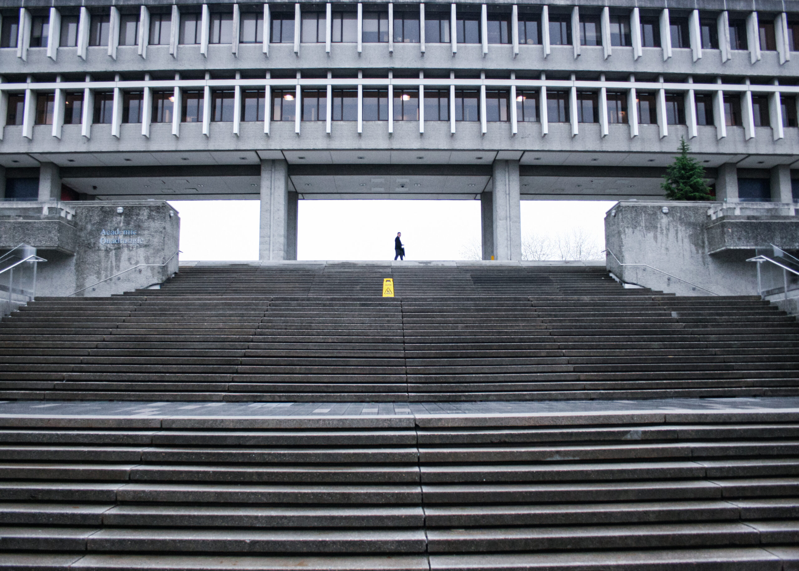 A figure standing in front of the SFU AQ