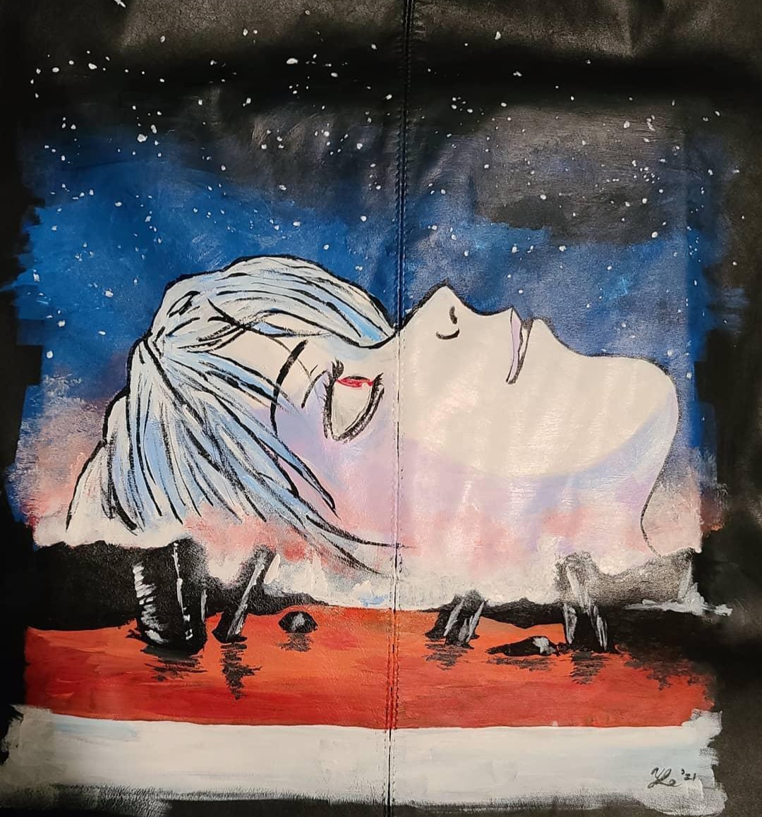 Close up of a black leather jacket with a hand-painted image of a side profile anime bust with white skin, red eyes, and icy blue hair. The person is looking up at a starry sky while red water sits below