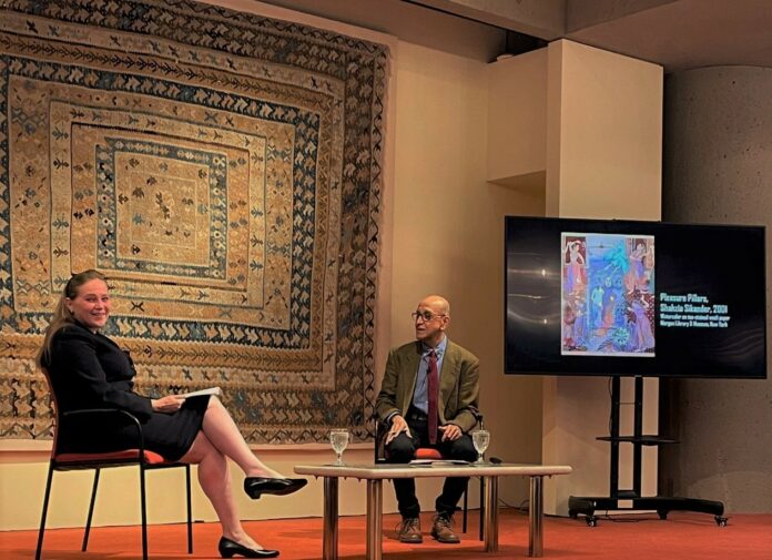 2 two people, one sitting on the left is Dr. al-Khamis, and Dr. Sajoo sits on the right