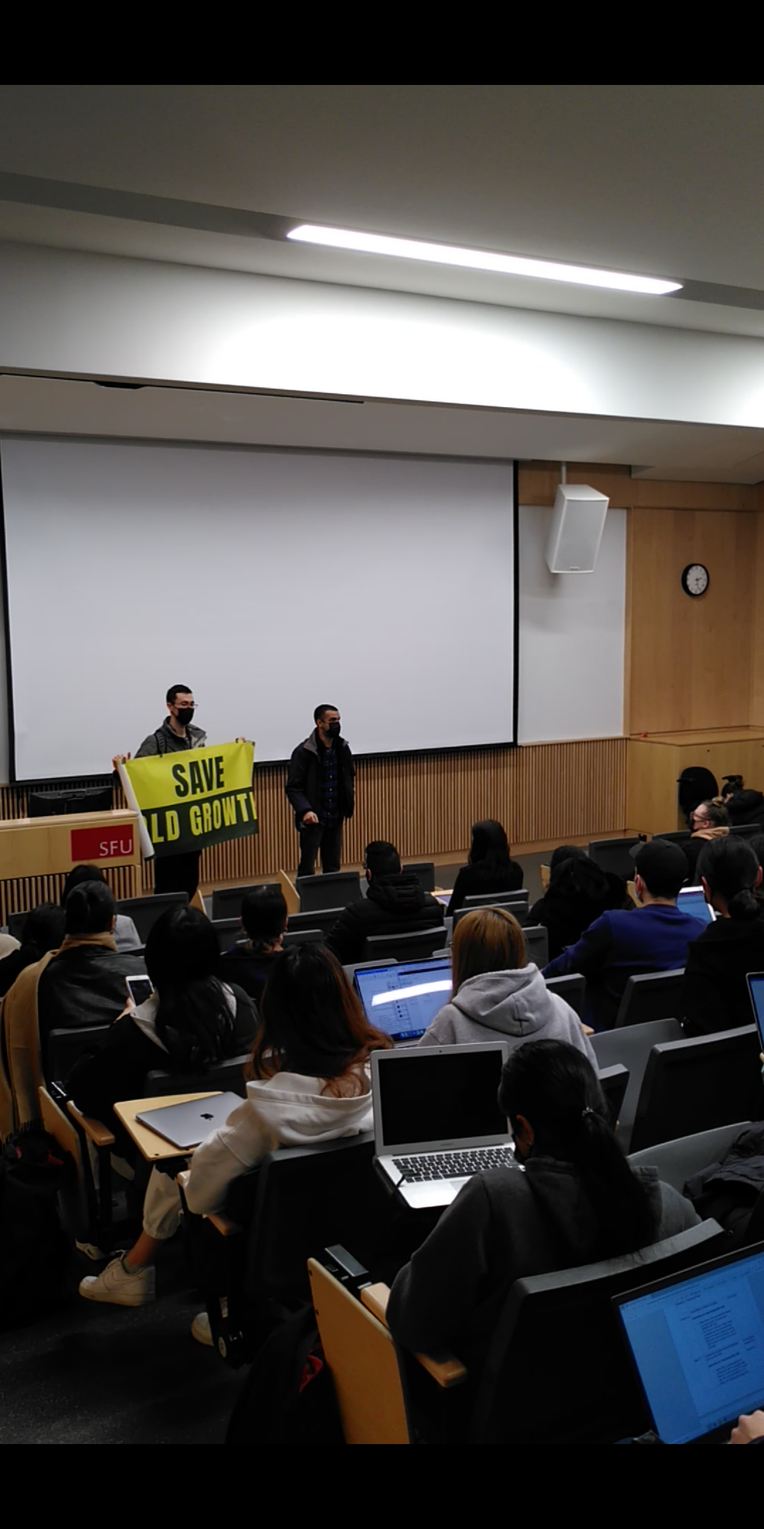 Two activists disrupting a lecture.