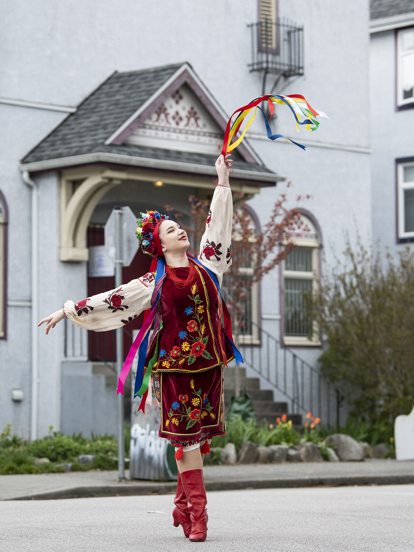 A young Ukrainian dancer is pictured in her colourful traditional dance costume in front of the Vancouver Ukraine Cultural Centre building