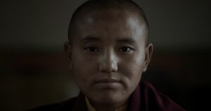 face and shoulders of a woman with a shaved head