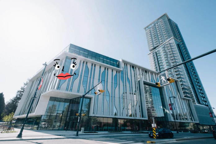 surrey-it-campus A photo of the SFU Surrey campus with a hot pink bow doodled on the top of the campus