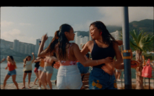Two Asian women dancing on the beach together in summer clothing