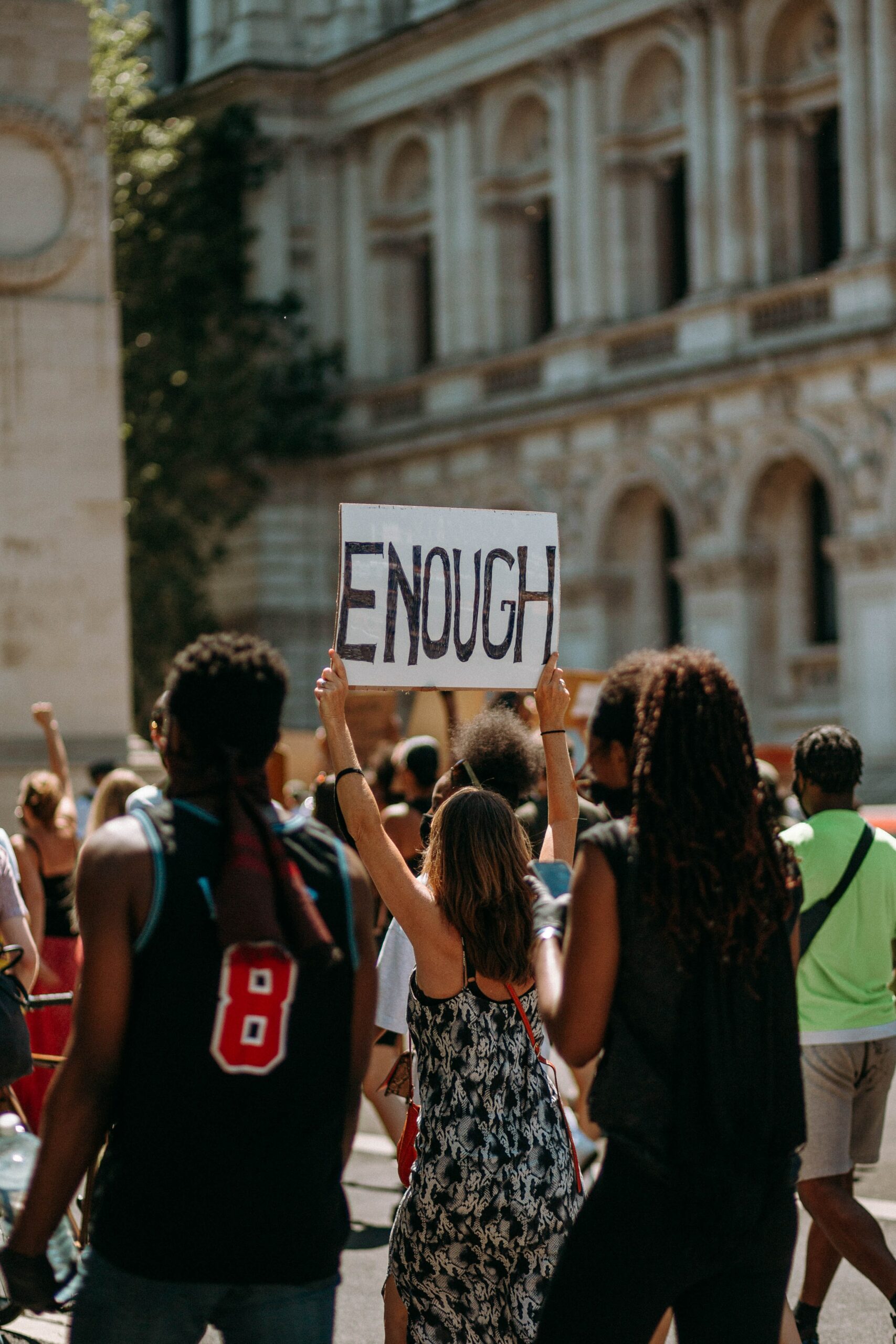 Protestor holding up an “enough” sign