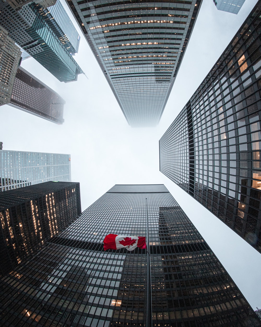 Canadian flag against skyscrapers