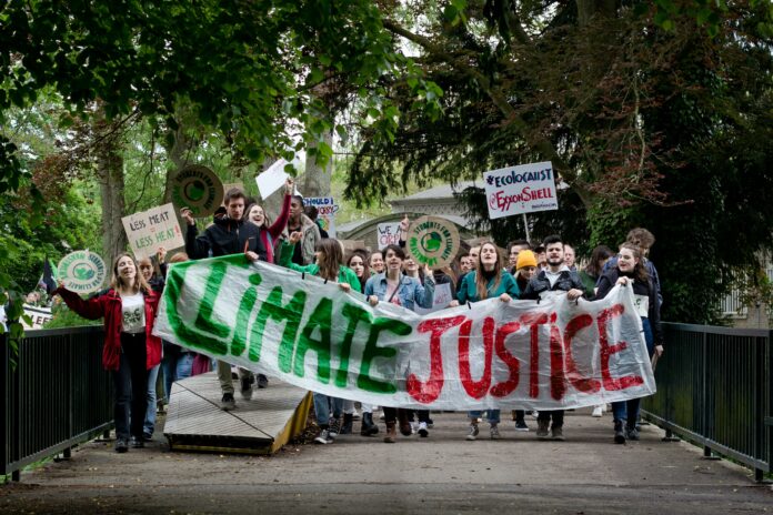 pexels-vincent-ma-janssen-2561628 A banner reading “climate justice” at a youth climate rally