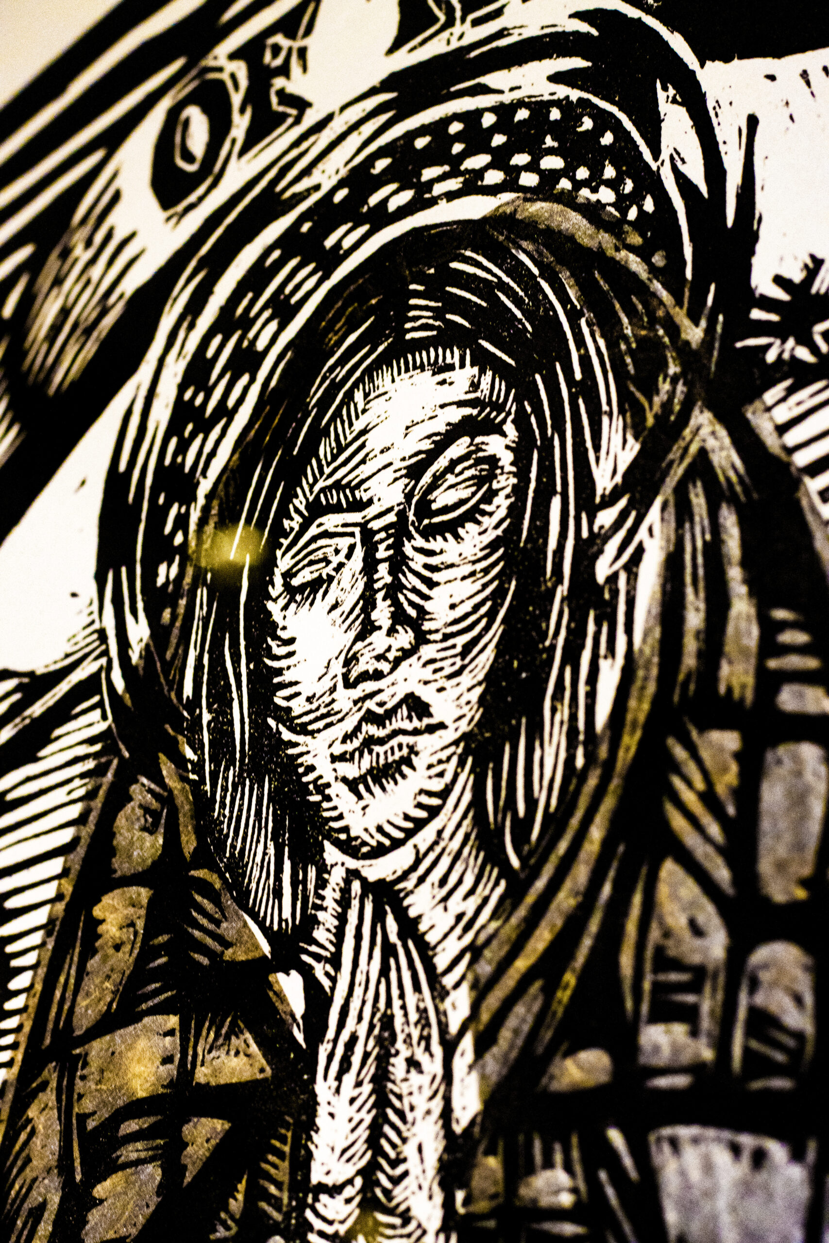 gold and white painting of a praying woman or saint