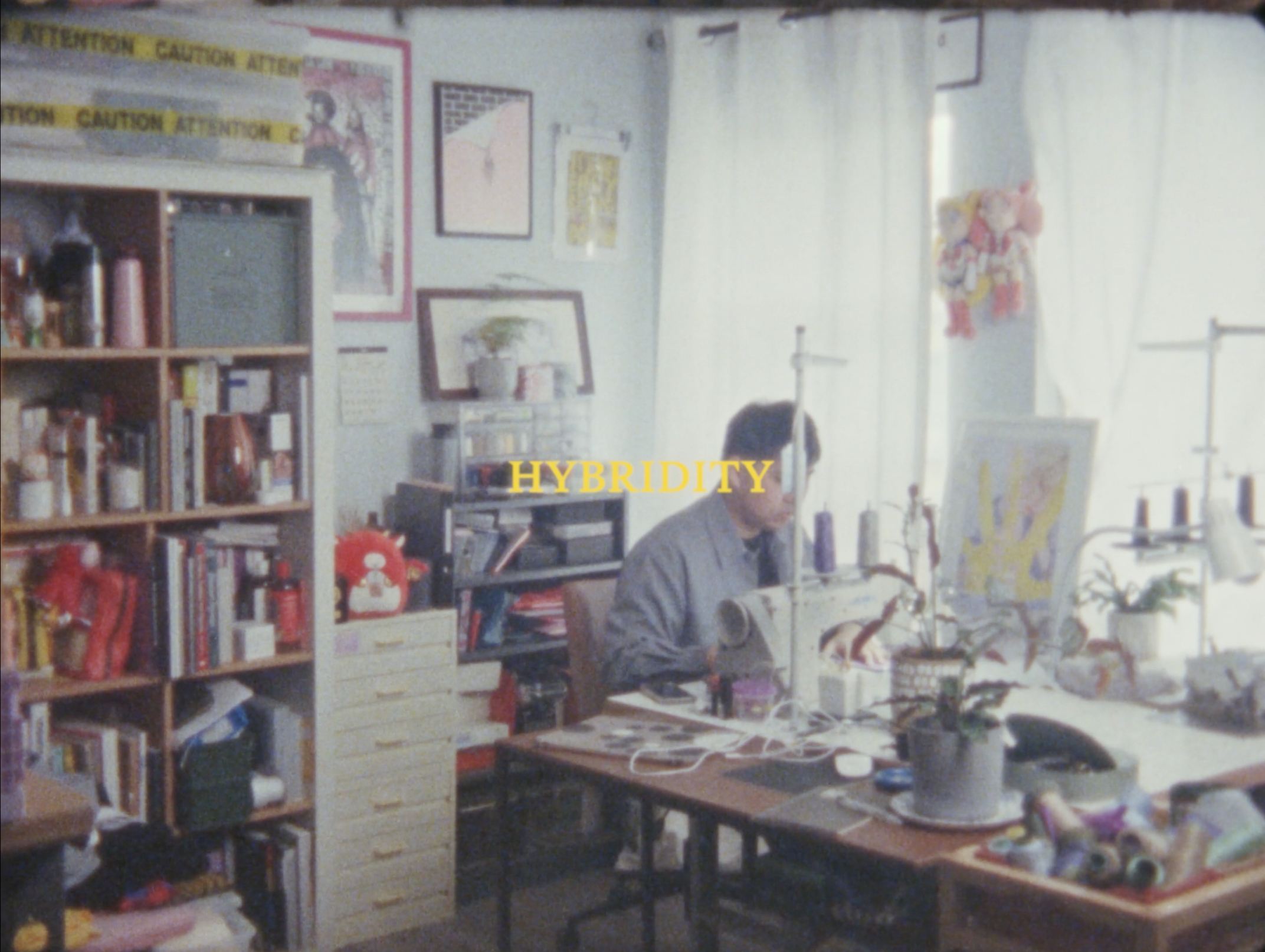 Fashion designer Alex S. Yu working at his workspace on his sewing machine