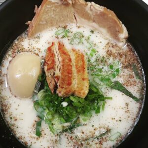 Bowl of ramen with pork, egg, and perilla toppings