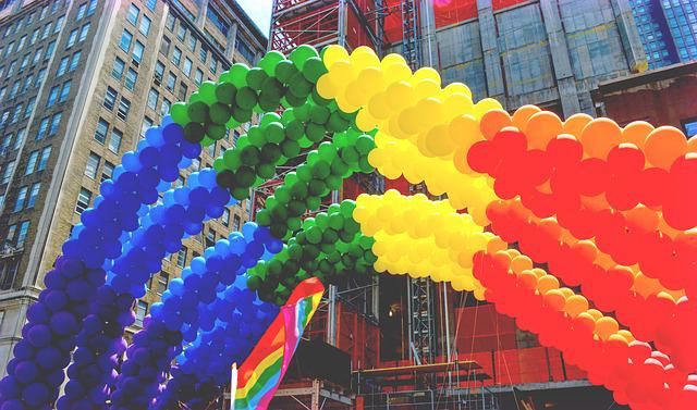 Colourful balloons forming a rainbow arch on the streets of New York