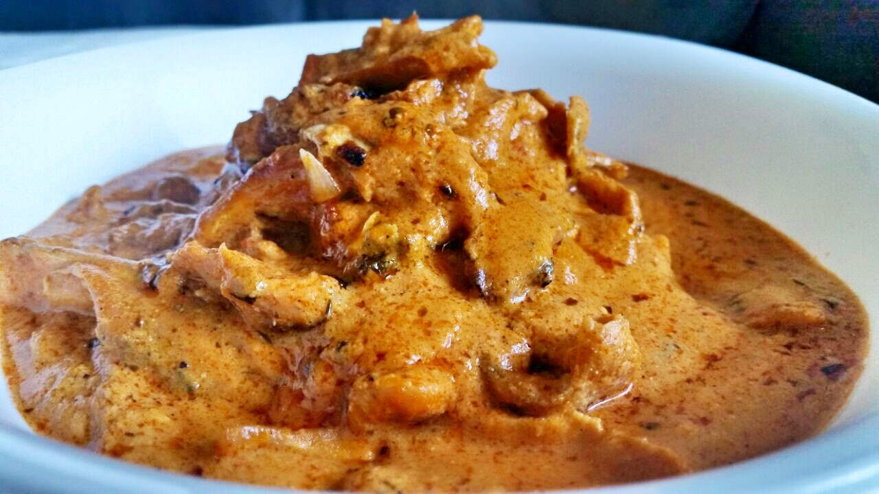 close-up shot of butter chicken piled on top of rice