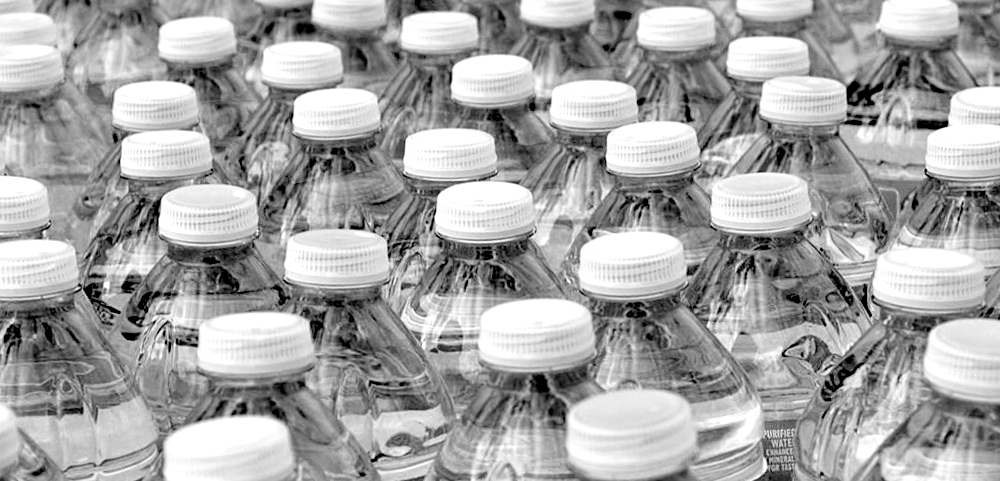 A photo of a few bottled waters lined next to each other