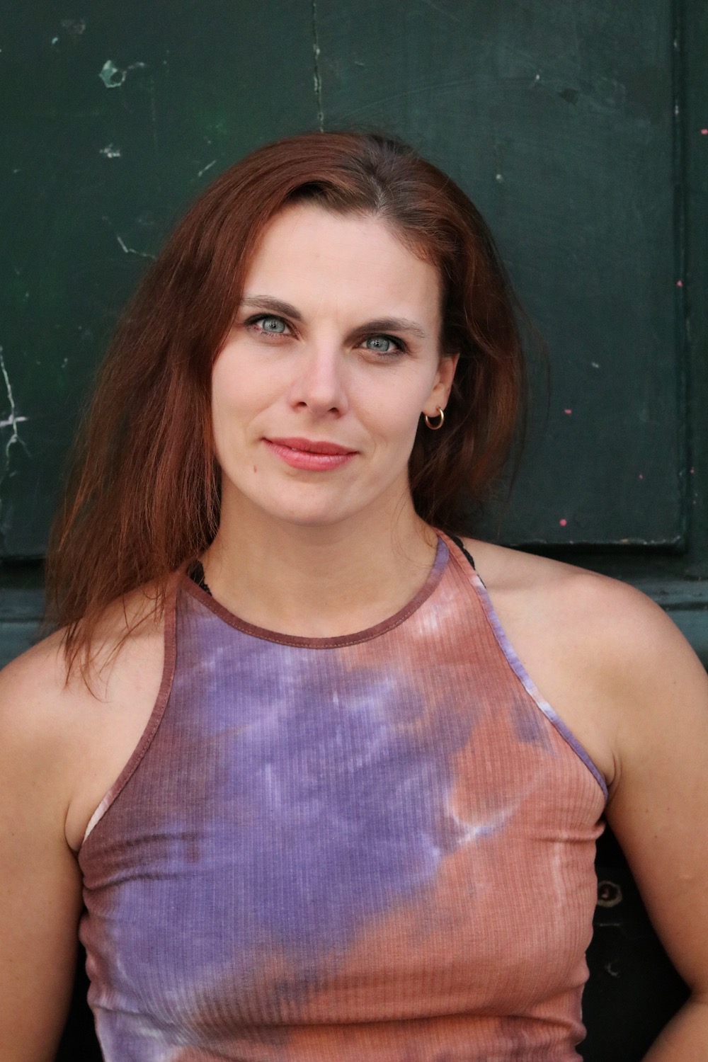 Professional headshot of Jenn Edwards, a Caucasian woman with reddish-brown hair and light blue eyes