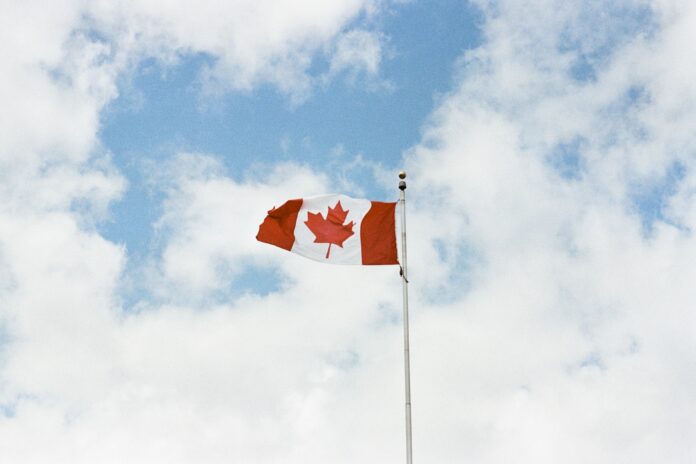 Canadian flag against blue sky
