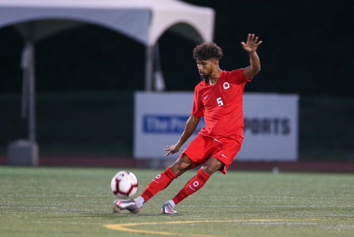 A15U4511_1_ Photo of soccer player Ali Zohar kicking a ball in a game.