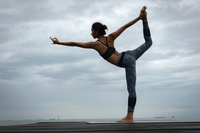 photo of a woman in Warrior 1 pose.
