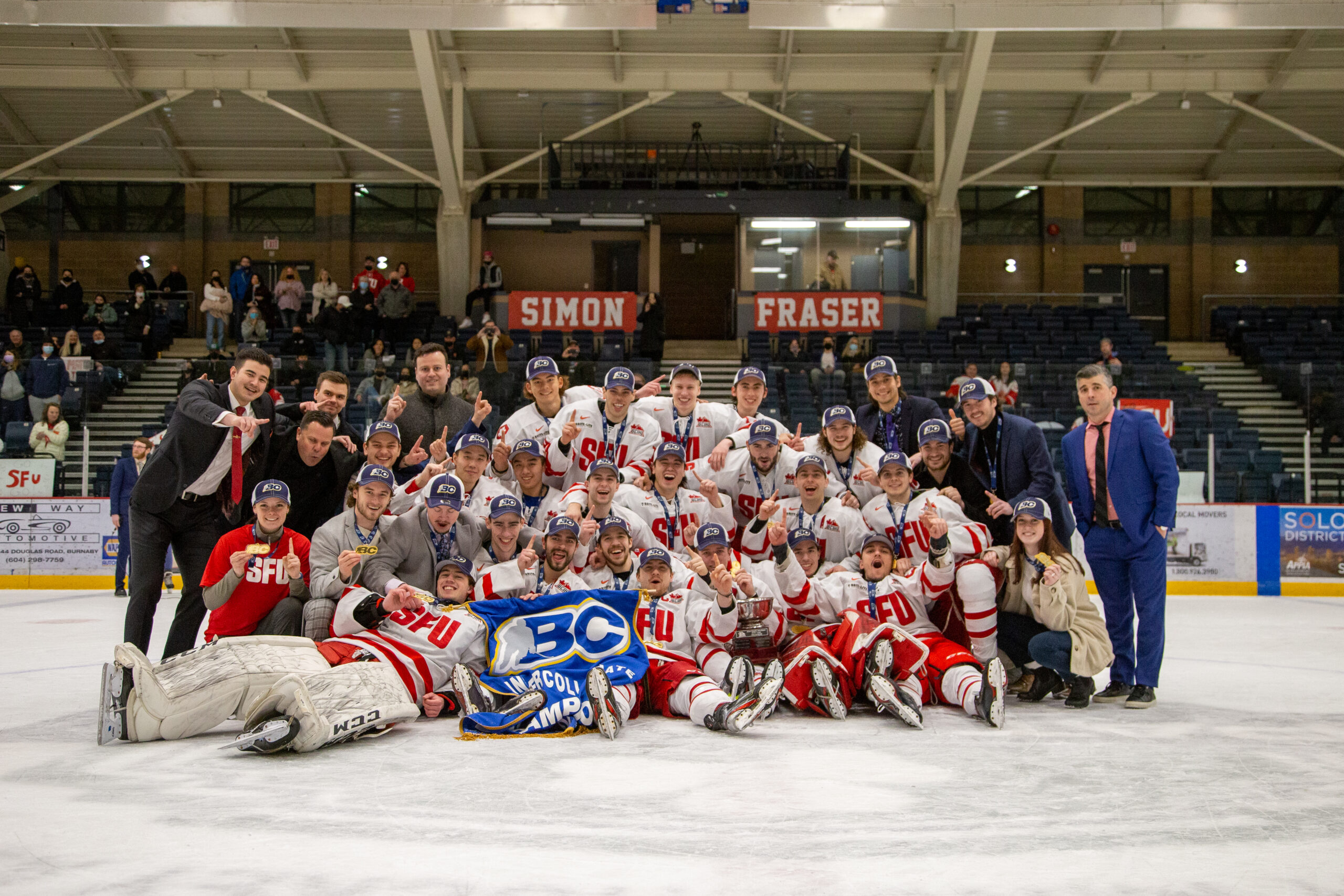 Photo of the SFU hockey team posing after winning the championship.