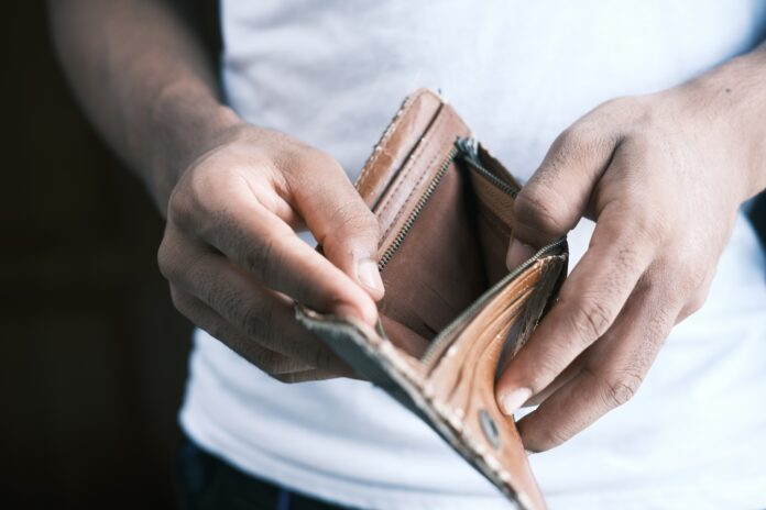 towfiqu-barbhuiya-3aGZ7a97qwA-unsplash(1) hand holding an empty wallet