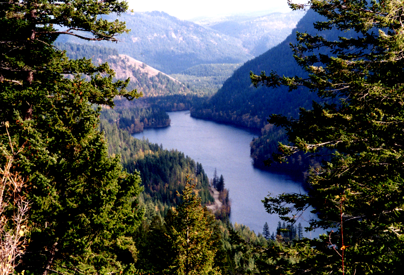 This photo is of Echo Lake in British Columbia. The photo is an aerial point of view, looking down at this small lake that is surrounded by forest.