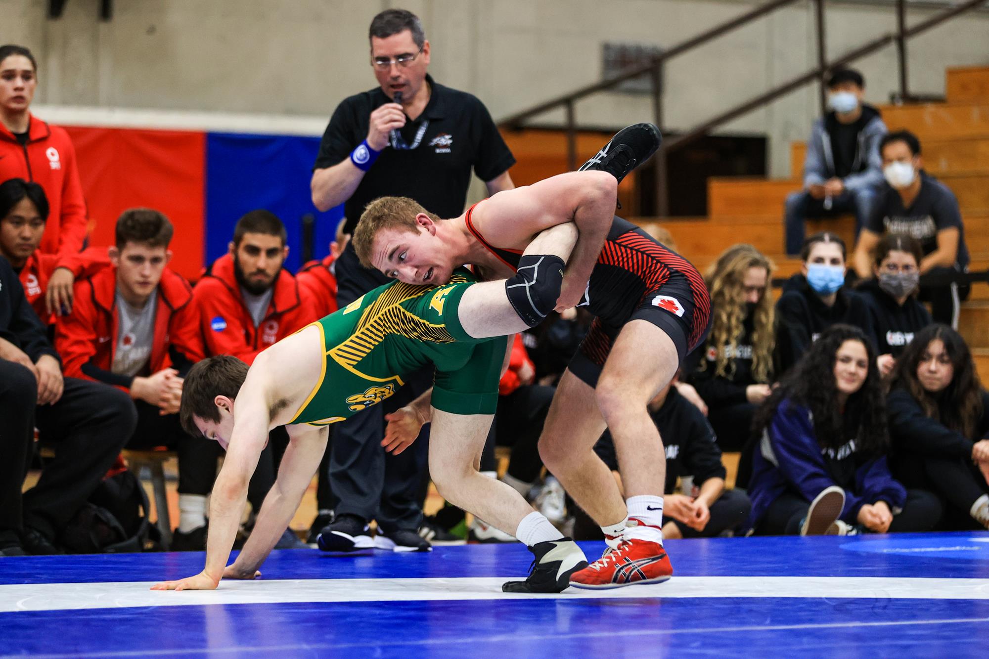 Photo of wrestler Sam Patton holding his opponents leg mid-competition.