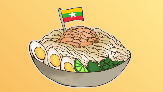 WEB-StellaLaurino_FoodForThought_BurmeseFood-100 Nan gyi thoke, a burmese noodle dish with eggs, lime, and green herbs topped with chicken in a bowl with a small Myanmar flag stuck in the dish.