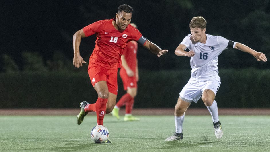photo of SFU forward Devin O’Hea protecting the ball from a defender.