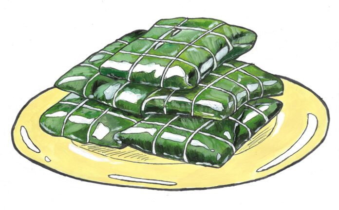 W13_Coverillustration2 Hallacas wrapped in banana leaves and strings on a plate.
