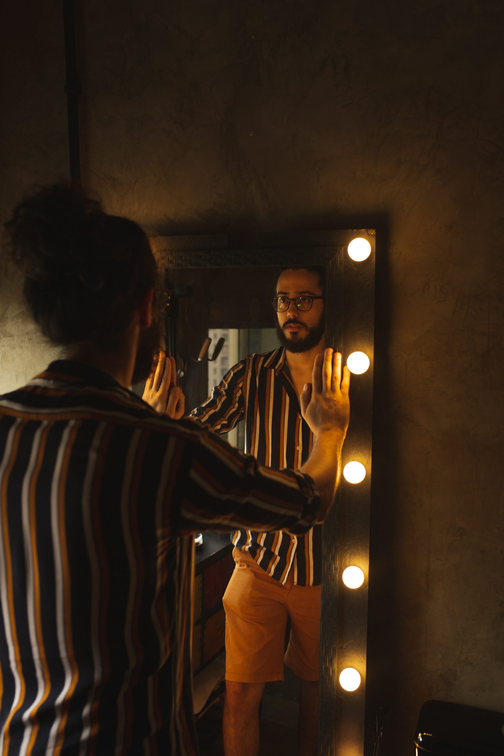 Photo of a person quirking their head in the mirror.